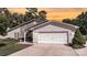 Charming home with stone accents, a well-manicured lawn, and a two-car garage at 7018 Huntsmaster Dr, Charlotte, NC 28277