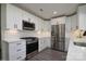 Well-lit kitchen with stainless steel appliances, white cabinets, and modern finishes, ready for cooking at 7018 Huntsmaster Dr, Charlotte, NC 28277