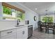 Modern kitchen featuring stainless steel appliances, bright countertops, and a view to the outdoor living at 7018 Huntsmaster Dr, Charlotte, NC 28277