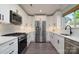 Modern kitchen with white cabinets, stainless steel appliances, and stylish backsplash, a chef's dream at 7018 Huntsmaster Dr, Charlotte, NC 28277