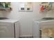 Bright laundry room features modern appliances and plenty of space for storage and folding at 7018 Huntsmaster Dr, Charlotte, NC 28277