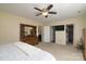 This main bedroom features an ensuite bathroom, walk-in closet, ceiling fan, and plush carpet at 7018 Huntsmaster Dr, Charlotte, NC 28277
