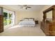 Sun-filled main bedroom features carpet, a ceiling fan, and large windows with outdoor views at 7018 Huntsmaster Dr, Charlotte, NC 28277
