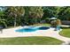 Relaxing backyard pool with lounge chairs, lush greenery, and a tranquil atmosphere for outdoor enjoyment at 7018 Huntsmaster Dr, Charlotte, NC 28277