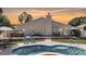 Gorgeous kidney-shaped pool with poolside lounge area and a hot tub, perfect for outdoor entertaining at 7018 Huntsmaster Dr, Charlotte, NC 28277
