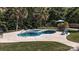Relaxing backyard featuring a kidney-shaped pool, spa, and lush landscaping at 7018 Huntsmaster Dr, Charlotte, NC 28277