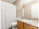 Bathroom with a granite vanity top, toilet, and shower featuring a white curtain at 7607 Petrea Ln, Charlotte, NC 28227
