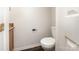 Powder room featuring a granite countertop, toilet, and doorway view, offering convenience for guests at 7607 Petrea Ln, Charlotte, NC 28227