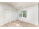 Bright bedroom featuring neutral carpet, two closets, and a window for plenty of natural light at 7607 Petrea Ln, Charlotte, NC 28227