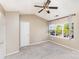 Spacious bedroom with neutral carpet, ceiling fan, and a window offering ample natural light at 7607 Petrea Ln, Charlotte, NC 28227