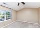 Bedroom featuring neutral carpet, a window, and a ceiling fan, creating a bright and airy space at 7607 Petrea Ln, Charlotte, NC 28227