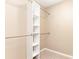 Walk-in closet with white shelving and hanging rods, maximizing storage and organization at 7607 Petrea Ln, Charlotte, NC 28227