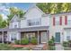 Charming two-story townhome with brick accents, neutral siding, and manicured landscaping at 7607 Petrea Ln, Charlotte, NC 28227