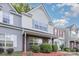 Charming townhouse with brick accents, colorful shutters, and well-maintained landscaping at 7607 Petrea Ln, Charlotte, NC 28227