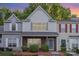 Charming two-story townhome with brick accents, neutral siding, and manicured landscaping at 7607 Petrea Ln, Charlotte, NC 28227
