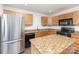 Well-equipped kitchen featuring stainless steel refrigerator, granite countertops, and ample storage at 7607 Petrea Ln, Charlotte, NC 28227