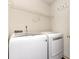 Laundry area with a modern washer and dryer, complete with shelving for storage at 7607 Petrea Ln, Charlotte, NC 28227