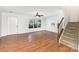 Living room featuring wood floors, staircase and large windows offering plenty of natural light at 7607 Petrea Ln, Charlotte, NC 28227