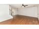 Spacious living room featuring wood floors, staircase and pendant lights at 7607 Petrea Ln, Charlotte, NC 28227