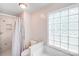 Well-lit bathroom features a tiled shower and glass block window for natural light at 812 Timber Creek Dr, York, SC 29745