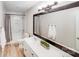 Bright bathroom featuring a double sink vanity, marble tiled shower/tub, and modern fixtures at 812 Timber Creek Dr, York, SC 29745