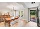 Light-filled dining room features wood table, bench, chairs, chandelier, and access to the front entryway at 812 Timber Creek Dr, York, SC 29745