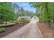 Long driveway leading to a beautiful house with a well-manicured yard and lush trees at 812 Timber Creek Dr, York, SC 29745