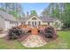 Charming home exterior with a wooden deck, stone pathway, and blooming azalea bushes at 812 Timber Creek Dr, York, SC 29745
