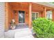 Inviting wood-clad porch with decorative front door, outdoor lighting, and lush greenery at 812 Timber Creek Dr, York, SC 29745