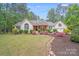Beautiful brick home with lush landscaping, colorful flower beds, and a well-manicured lawn at 812 Timber Creek Dr, York, SC 29745