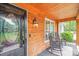 Inviting front porch with rocking chairs and beautiful wood detail, framed by blooming flowers at 812 Timber Creek Dr, York, SC 29745