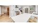 Modern kitchen with white cabinets, stainless steel appliances, and a large quartz countertop island at 812 Timber Creek Dr, York, SC 29745