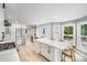 Bright kitchen features white cabinets, stainless steel appliances, and an island with barstool seating at 812 Timber Creek Dr, York, SC 29745