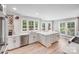 Bright kitchen with white cabinets, stainless steel appliances, quartz countertops, and ample natural light at 812 Timber Creek Dr, York, SC 29745