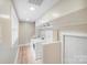 Clean and functional laundry room featuring a washer, dryer, built-in shelves, and natural light at 812 Timber Creek Dr, York, SC 29745