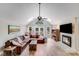 Spacious living room with high ceilings, a fireplace, large windows, and a comfortable leather couch at 812 Timber Creek Dr, York, SC 29745