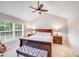 Cozy main bedroom boasts a ceiling fan, vaulted ceilings, and a bench in front of the bed at 812 Timber Creek Dr, York, SC 29745