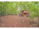 Two-story outbuilding in the wooded backyard offers a unique space for hobbies or storage at 812 Timber Creek Dr, York, SC 29745