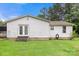 Back exterior view with a lawn and an entrance to the home, and a window at 814 Columbia Dr, Chester, SC 29706