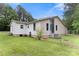 Spacious backyard featuring a well-maintained lawn, partial fence, and exterior views of the home at 814 Columbia Dr, Chester, SC 29706