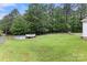 Large backyard with an above ground pool and a deck surrounded by green grass at 814 Columbia Dr, Chester, SC 29706