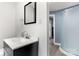 Bathroom featuring white countertops, black framed mirror, step-in shower, and modern fixtures at 814 Columbia Dr, Chester, SC 29706