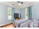 Bright bedroom with two windows, a ceiling fan, and a bed with blue and red accents at 814 Columbia Dr, Chester, SC 29706