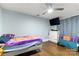A cheerful bedroom with blue walls, wood floors and ceiling fan at 814 Columbia Dr, Chester, SC 29706
