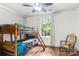 Bedroom featuring bunk beds, hardwood floors, rocker and natural light at 814 Columbia Dr, Chester, SC 29706