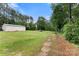 The barn on a large lot features lush green grass and mature trees, offering a private oasis at 814 Columbia Dr, Chester, SC 29706