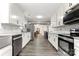 Bright kitchen with stainless appliances, white cabinets, and wood floors offers a modern design at 814 Columbia Dr, Chester, SC 29706