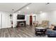 Cozy living room featuring a fireplace, TV, neutral walls and wood-look floors at 814 Columbia Dr, Chester, SC 29706