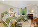 Comfortable bedroom featuring two twin beds, a desk, and a view of the outdoors at 916 Cherokee Rd, Charlotte, NC 28207