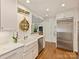 Updated kitchen with stainless steel appliances, white cabinets, marble countertops, and a breakfast bar at 916 Cherokee Rd, Charlotte, NC 28207